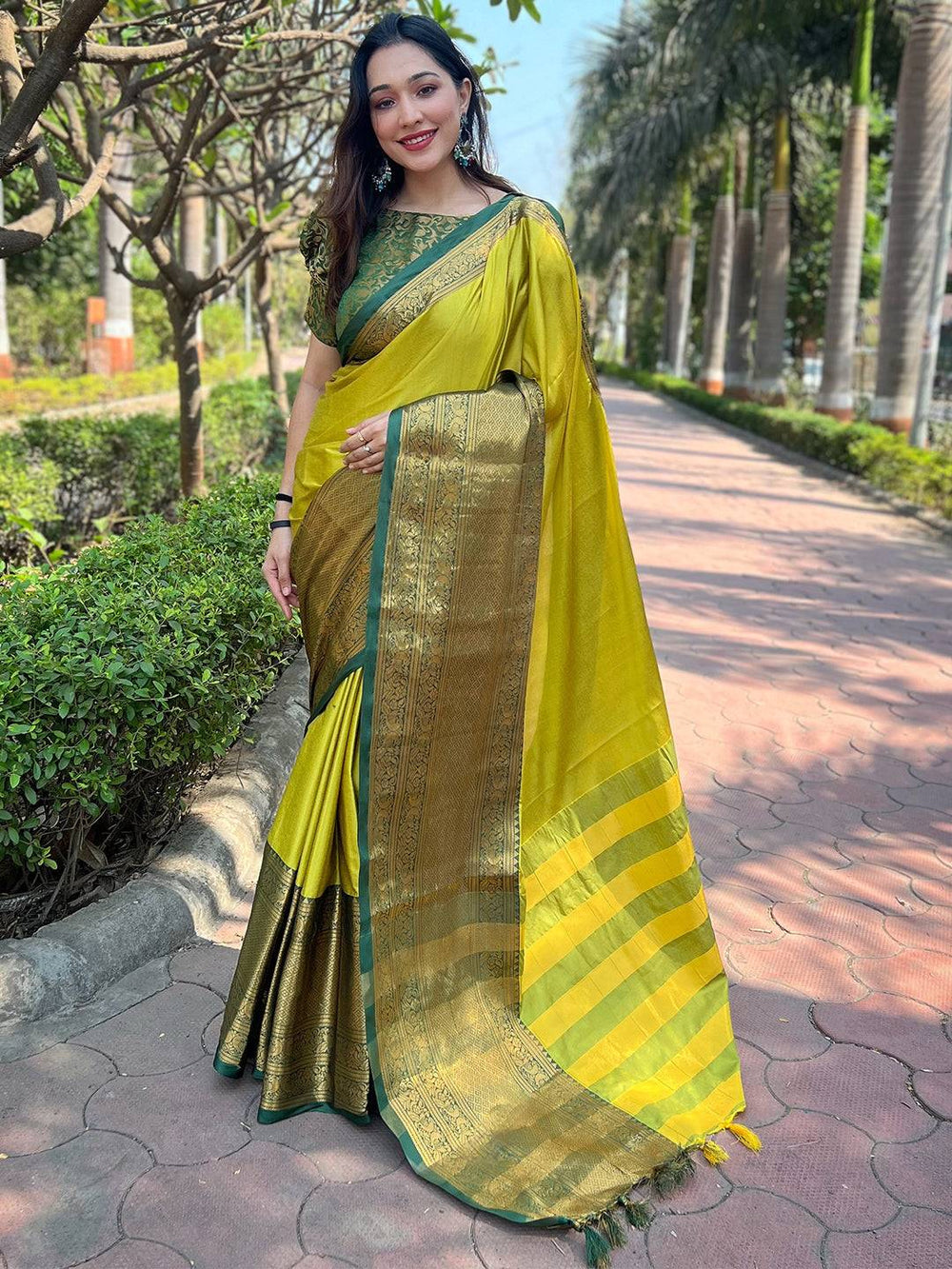 Full view of light green Kanjivaram saree with gold detailing