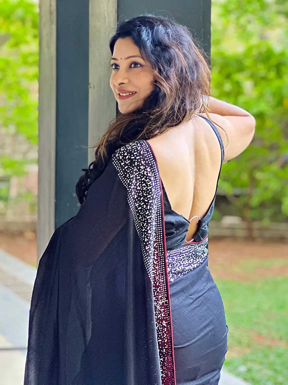Back view of black poly silk saree with detailed border