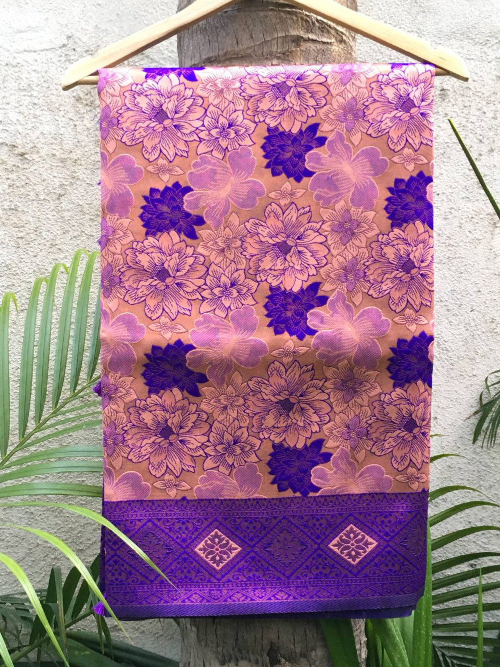 Violet soft silk butta weaving saree on hanger.