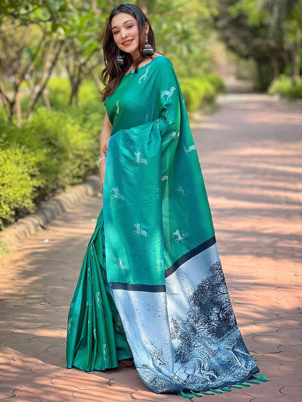 Elegant green silk saree with detailed zari pallu, outdoor scene