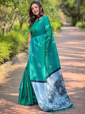 Elegant green silk saree with detailed zari pallu, outdoor scene
