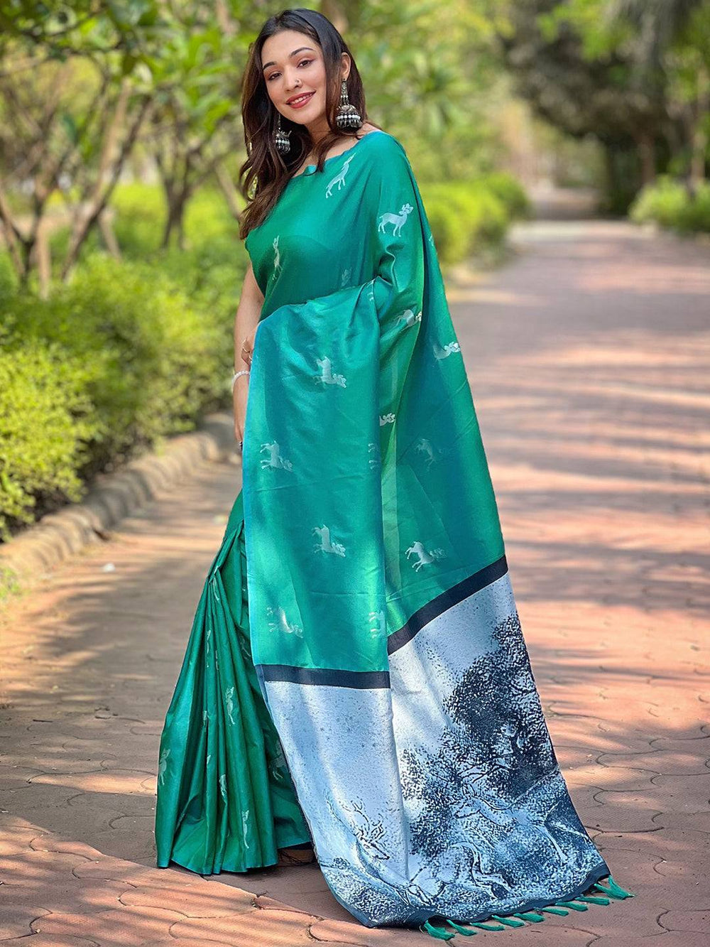 Elegant green silk saree with detailed zari pallu, outdoor scene