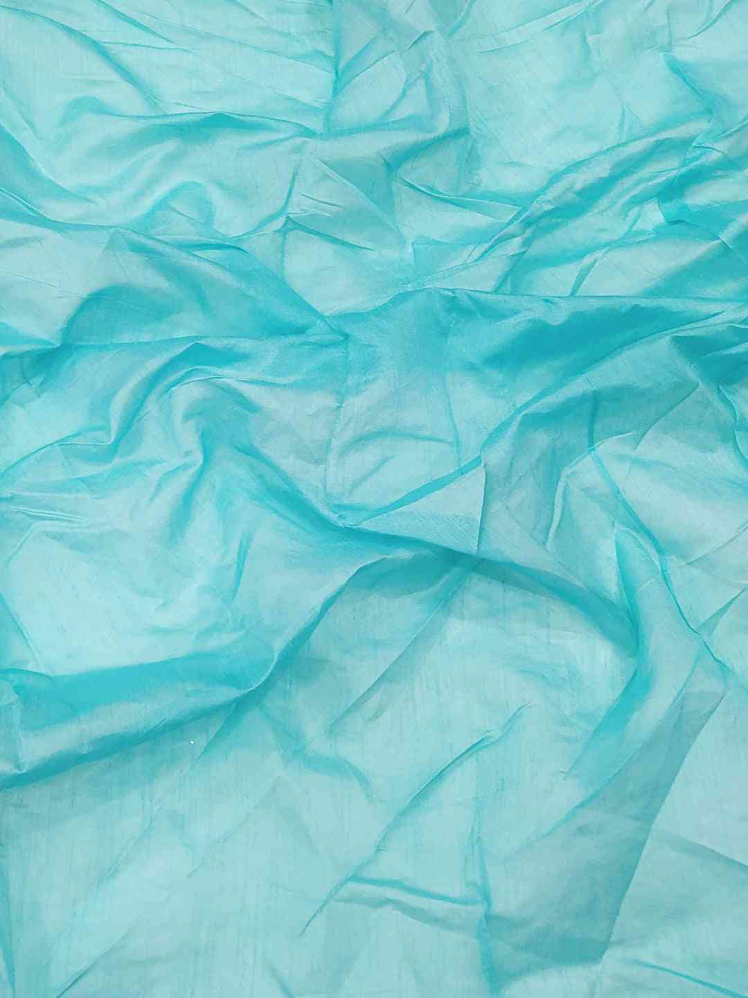 Close-up of delicate net fabric in vibrant turquoise color