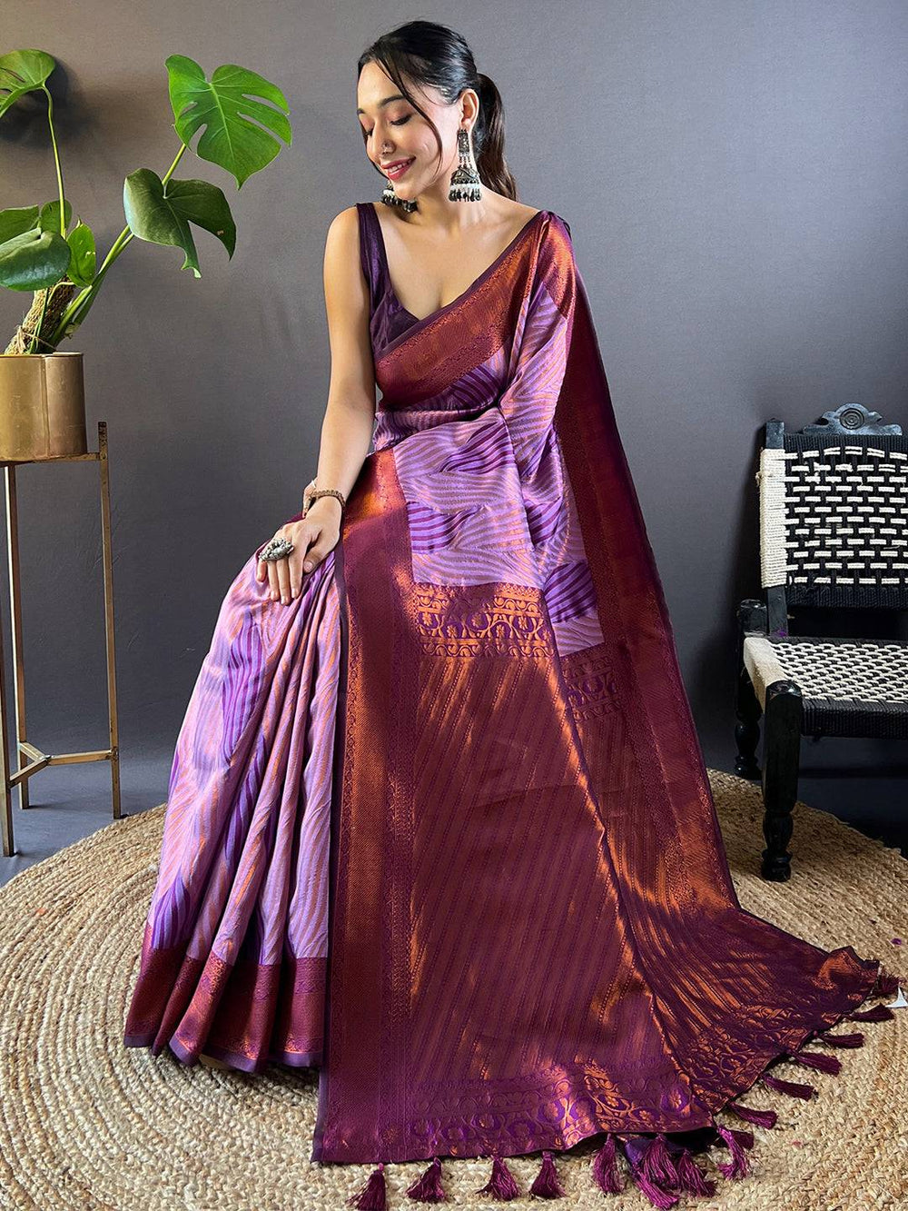 Model seated in lavender tussar silk ikkat saree