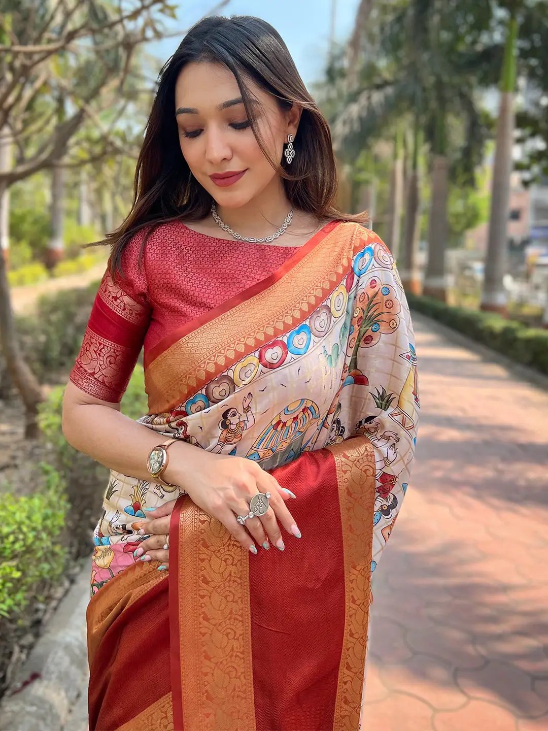 Model wearing a Banarasi saree with ornate design and vibrant hues