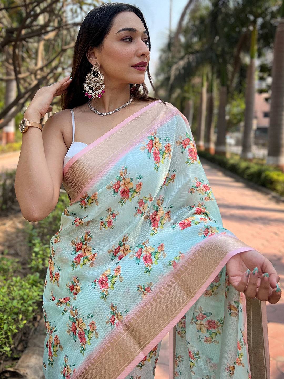 Close-up of turquoise Kota saree with digital floral pattern.
