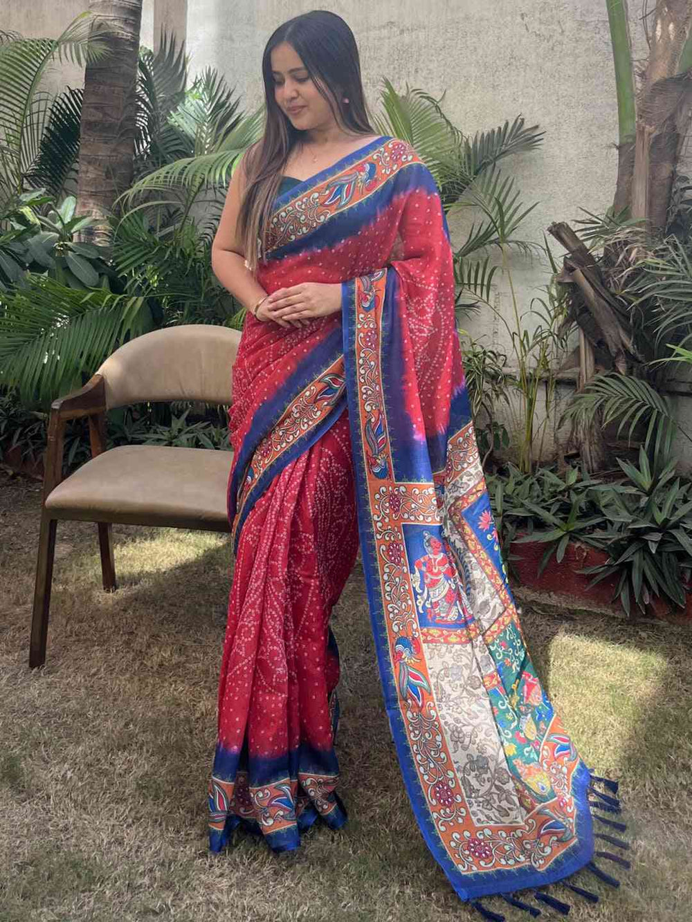 Red linen saree with Bandhej and kalamkari print, hands clasped