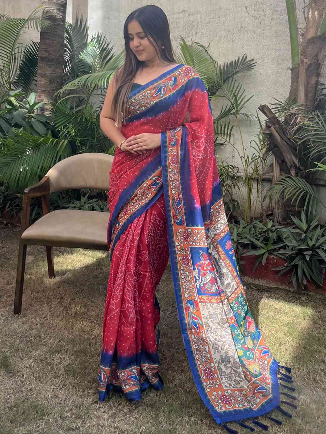 Red linen saree with Bandhej and kalamkari print, hands clasped