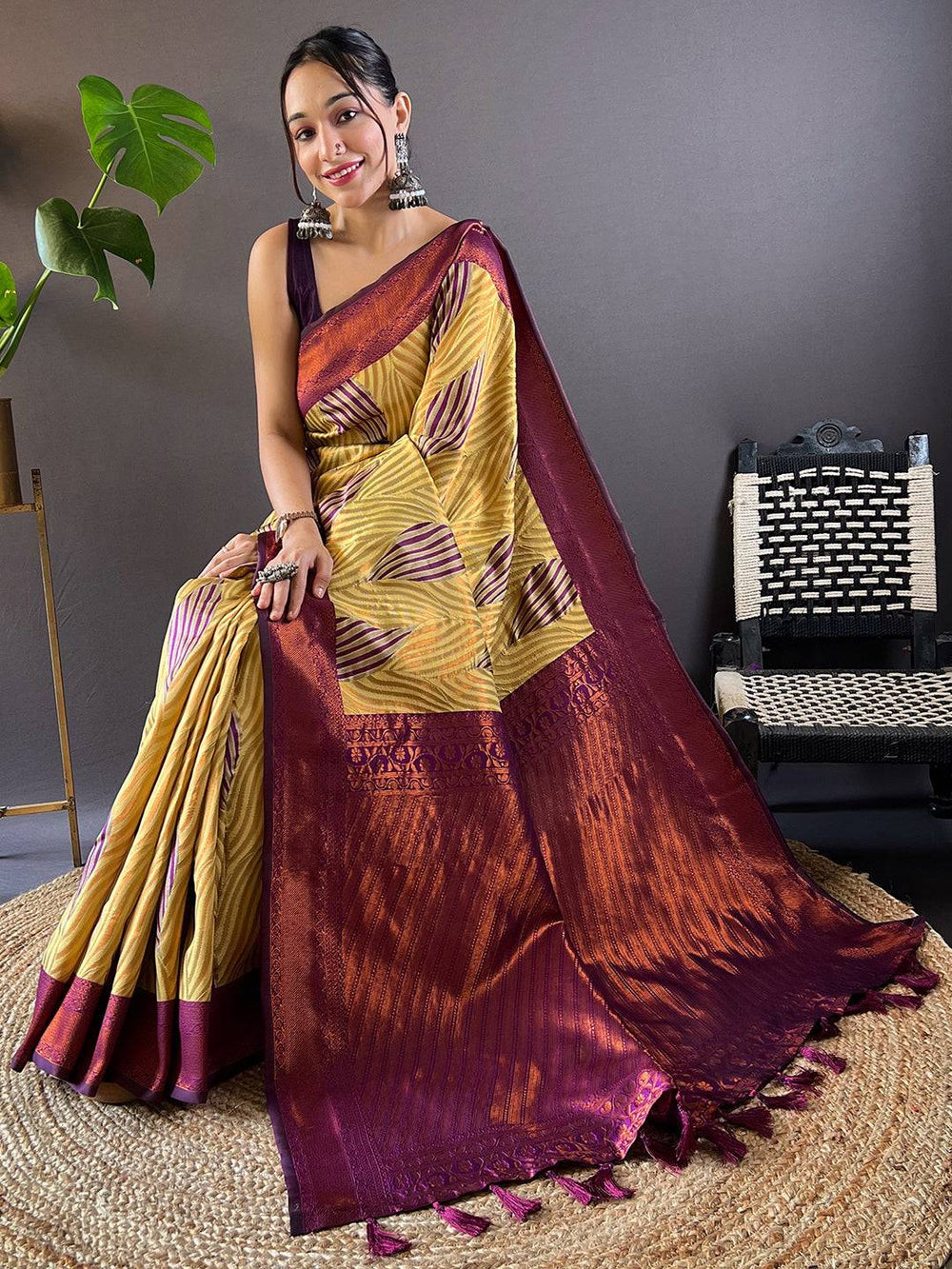 Seated model showcasing Olive Tussar Silk Ikkat Saree design