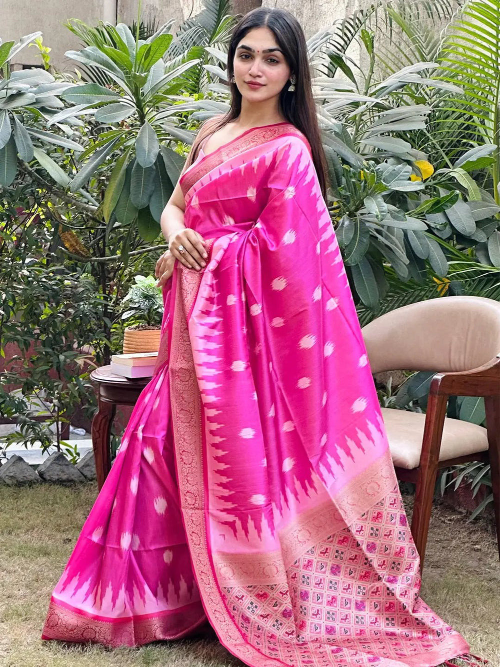 Model in pink Banarasi saree with intricate zari patola design