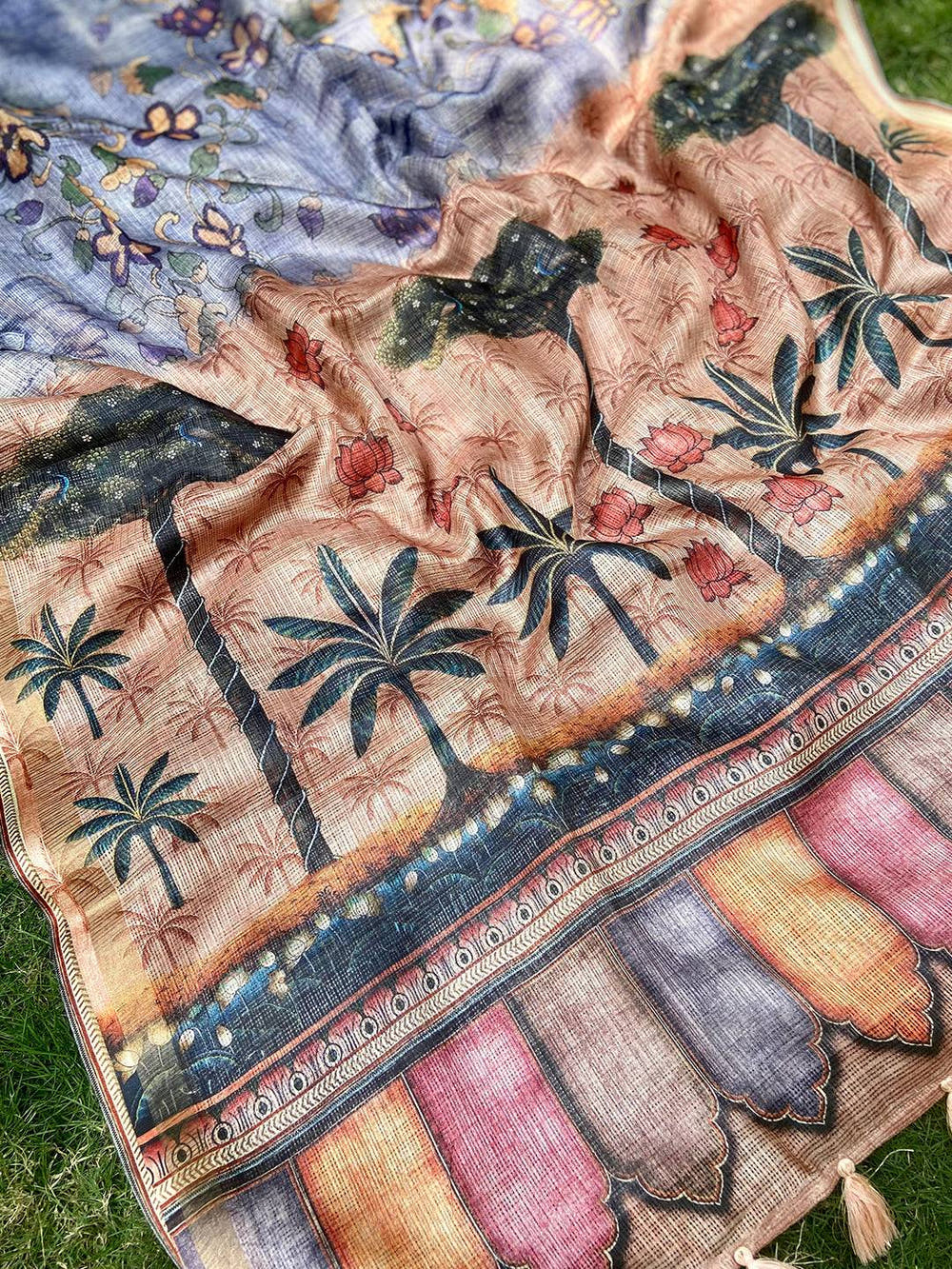 Detailed view of floral patterns on blue Kota Doriya silk saree.