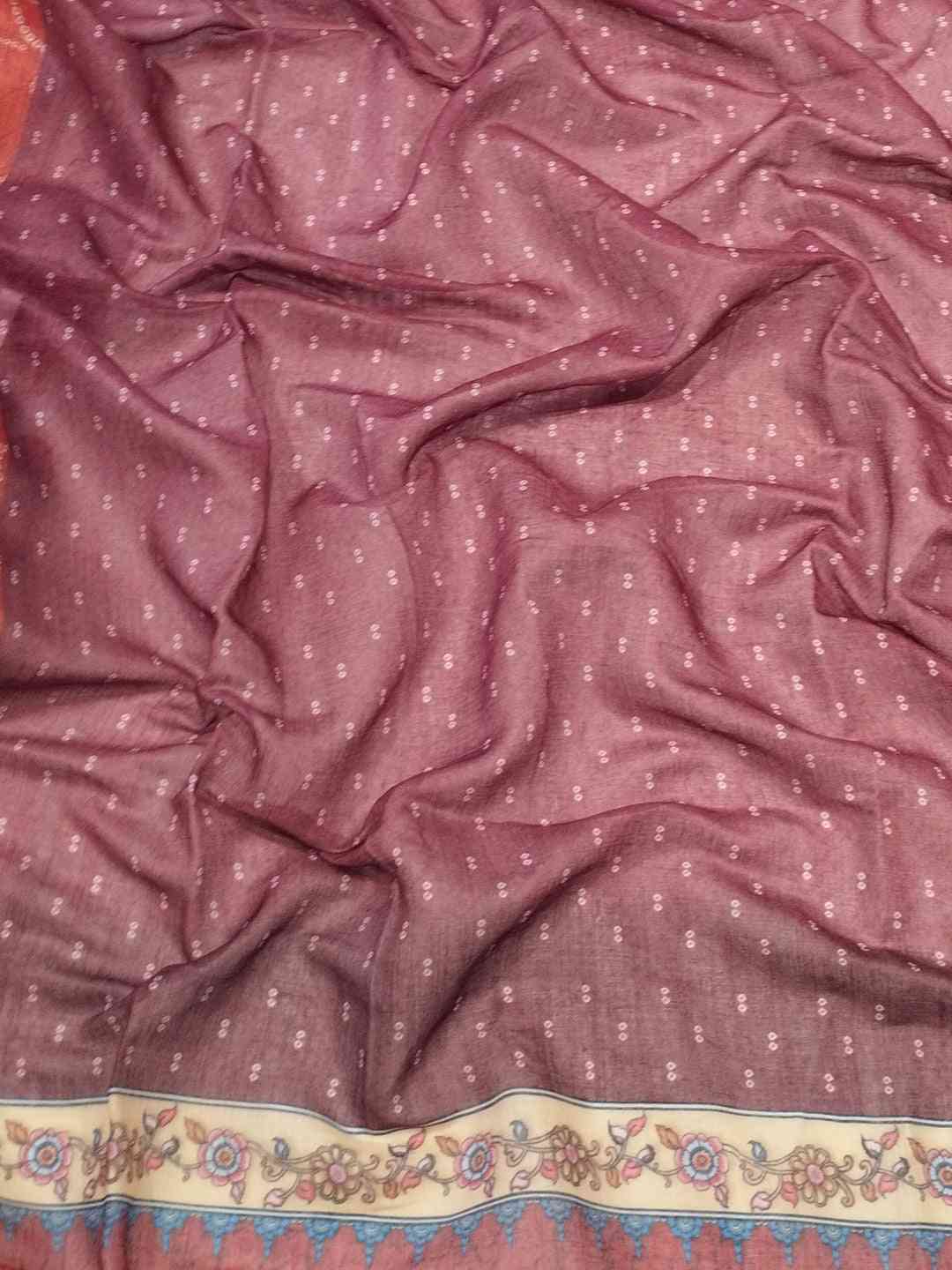Close-up of red linen saree fabric with Bandhej pattern