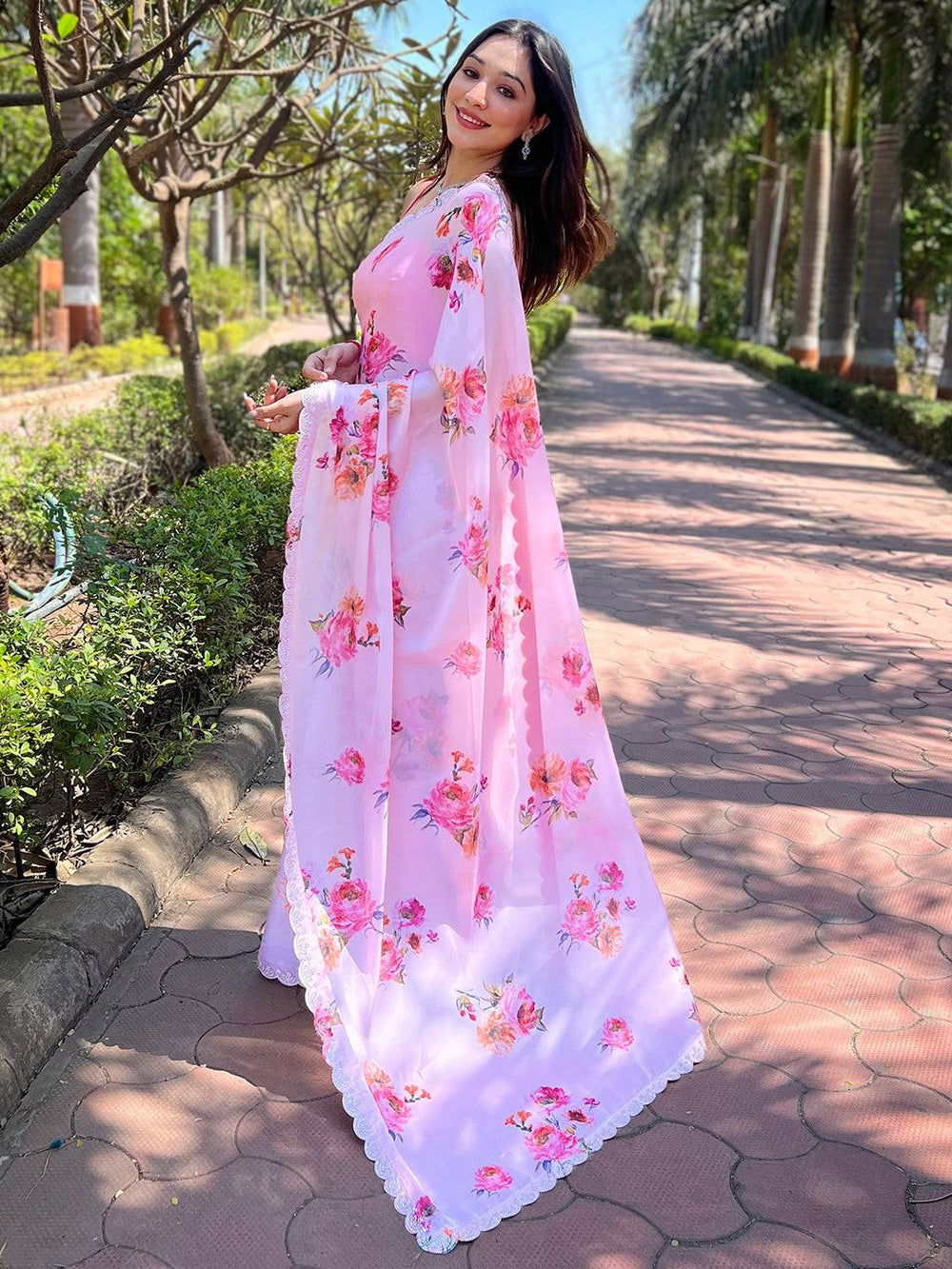 Back view of pink floral satin georgette saree with zircon border