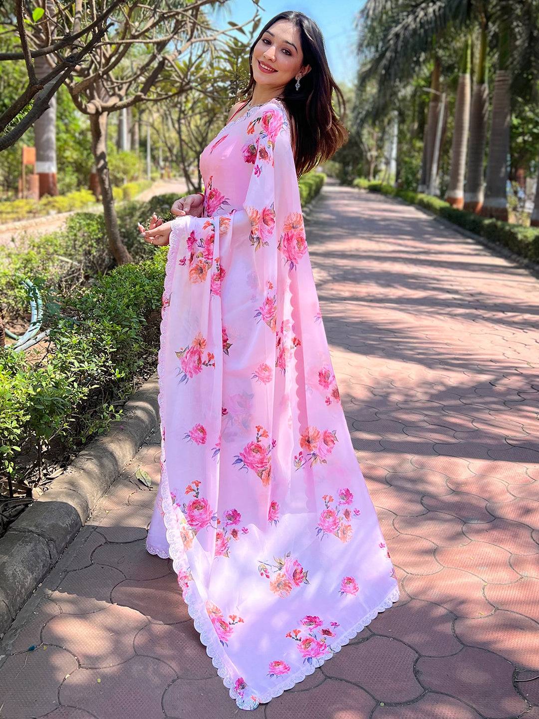 Back view of pink floral satin georgette saree with zircon border