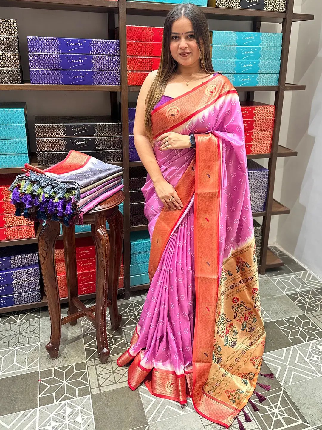 Pink Bandhani saree with Paithani border in a colorful store