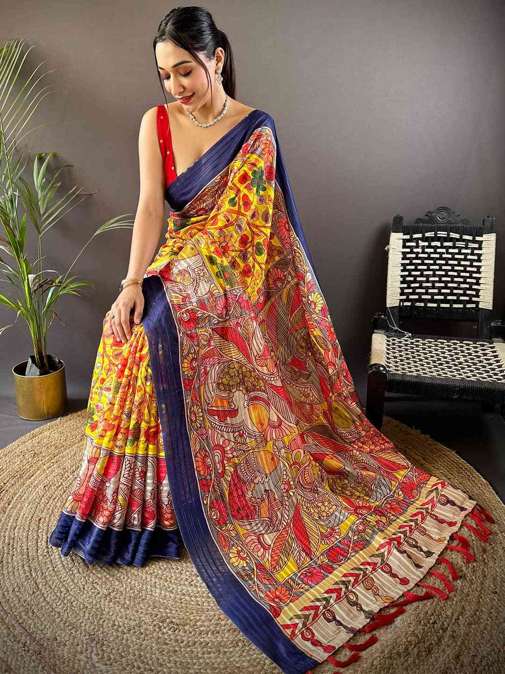 Seated model with Sunshine Yellow Pen Kalamkari Linen Saree