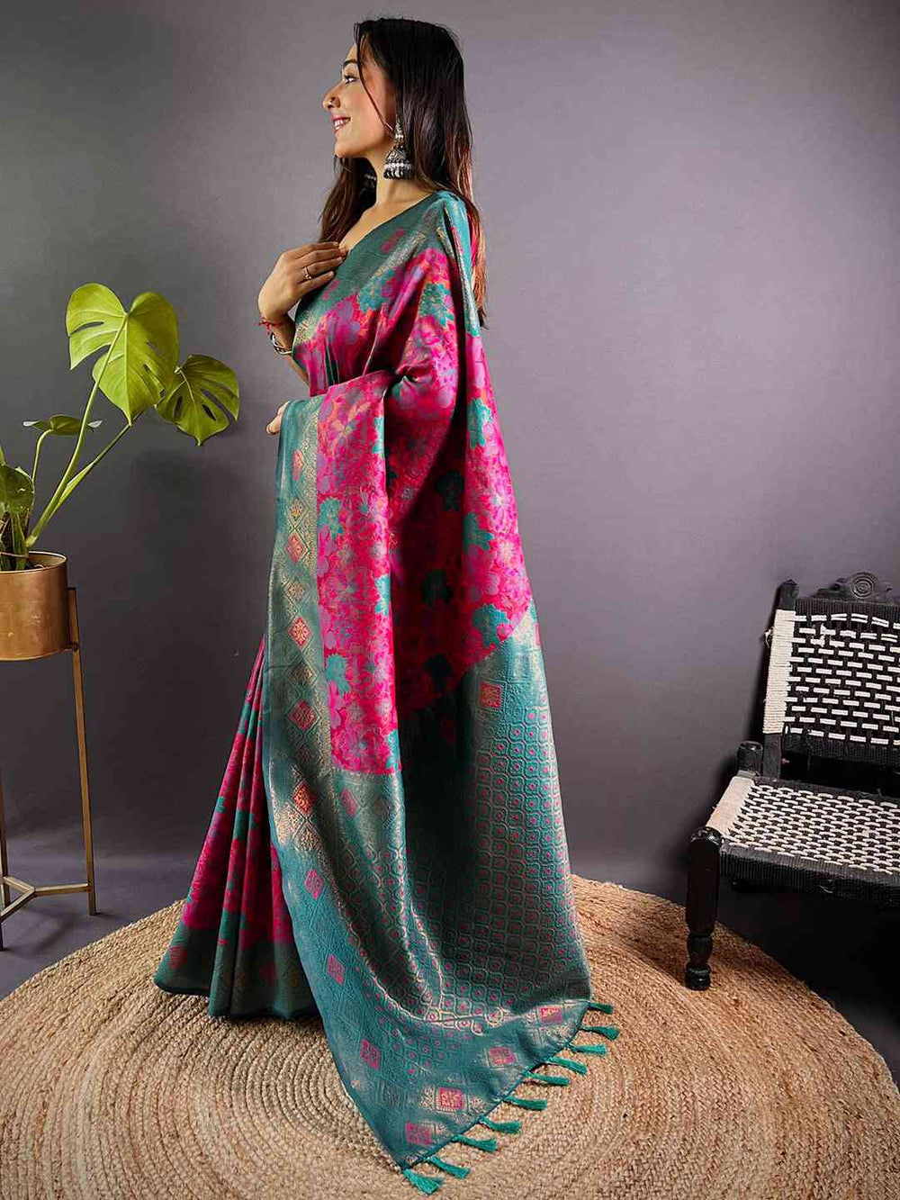 Model wearing deep pink silk saree with green accents