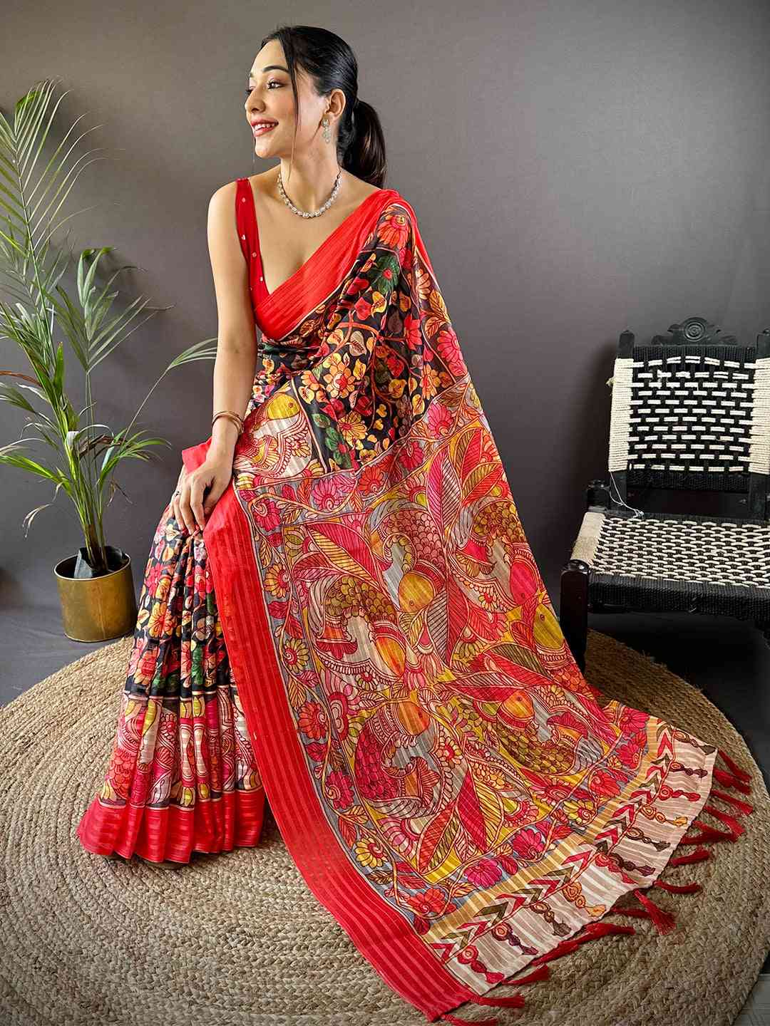 Model seated in Raven Black Pen Kalamkari Linen Saree