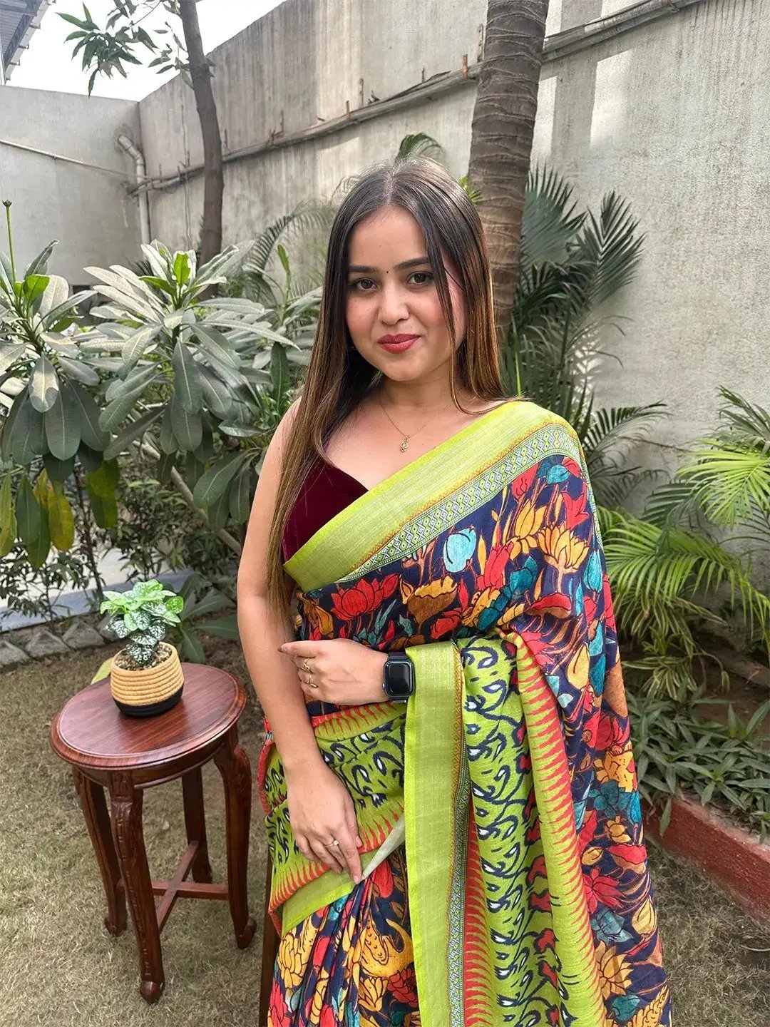 Close-up of woman in floral Ikkat saree with green accents