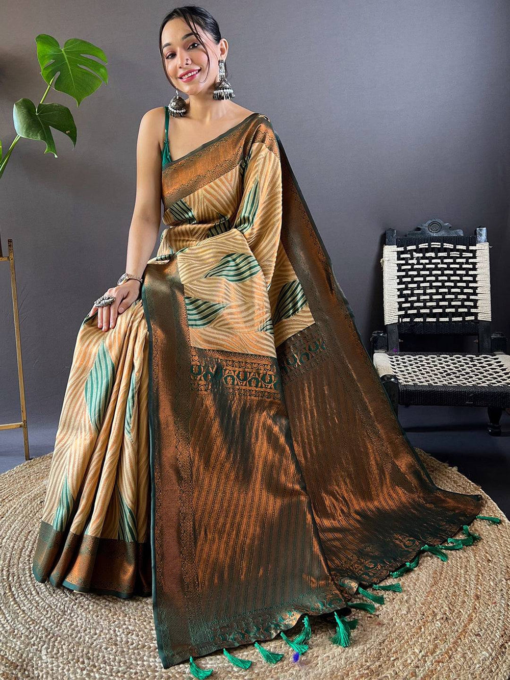 Model seated in elegant brown Tussar silk Ikkat saree.