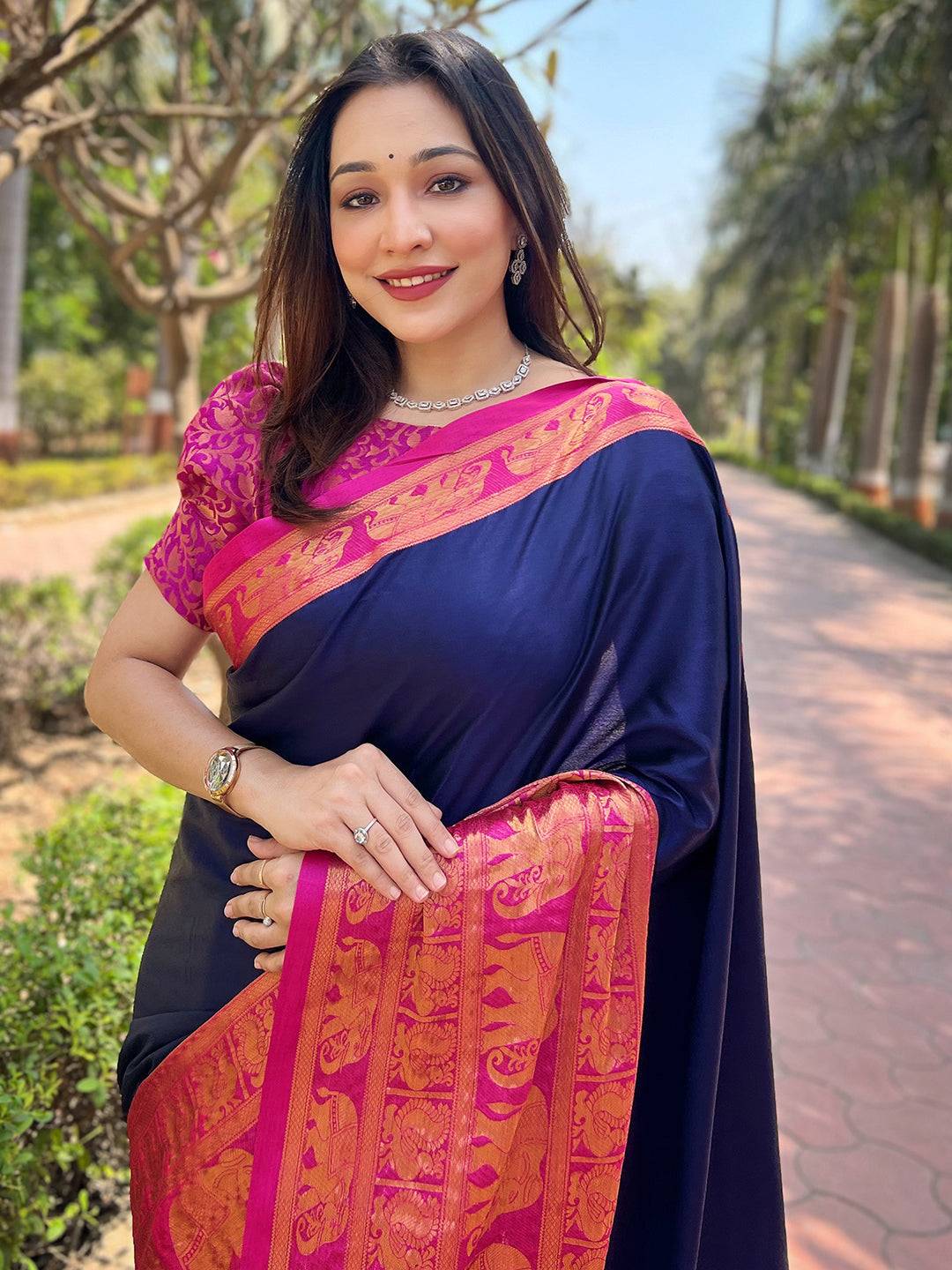 Navy Kanjivaram saree with pink brocade blouse, outdoor setting