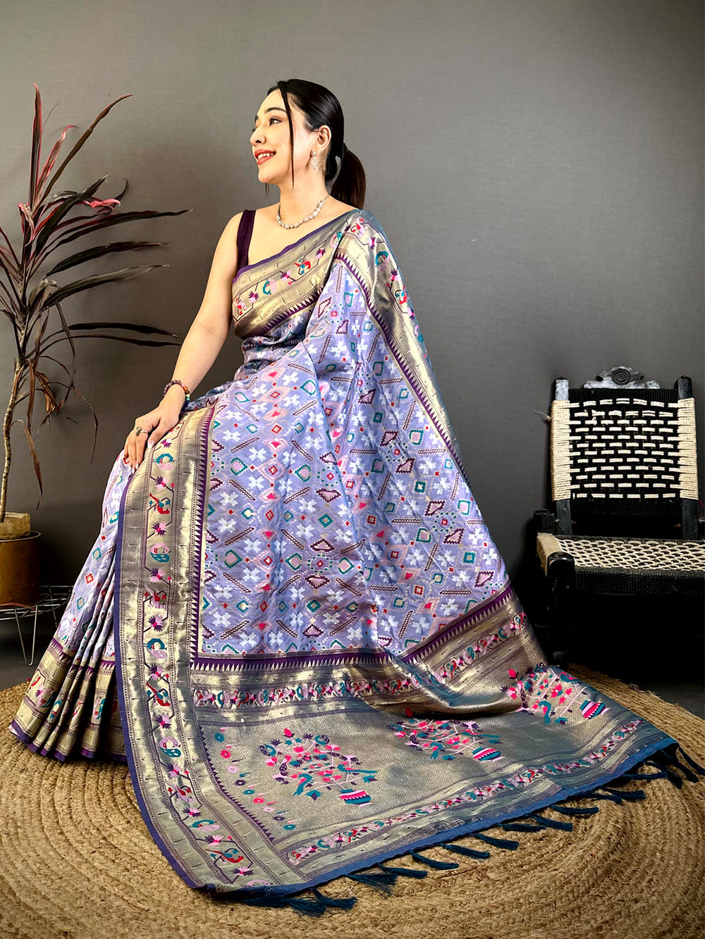 Light Lavender Patola Silk Zari Weaving Saree displayed on grass for outdoor fashion shoot