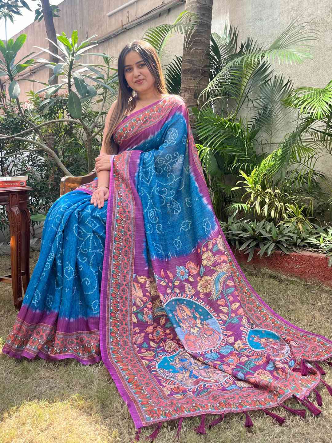 Blue linen saree with Bandhej and Kalamkari print, seated pose