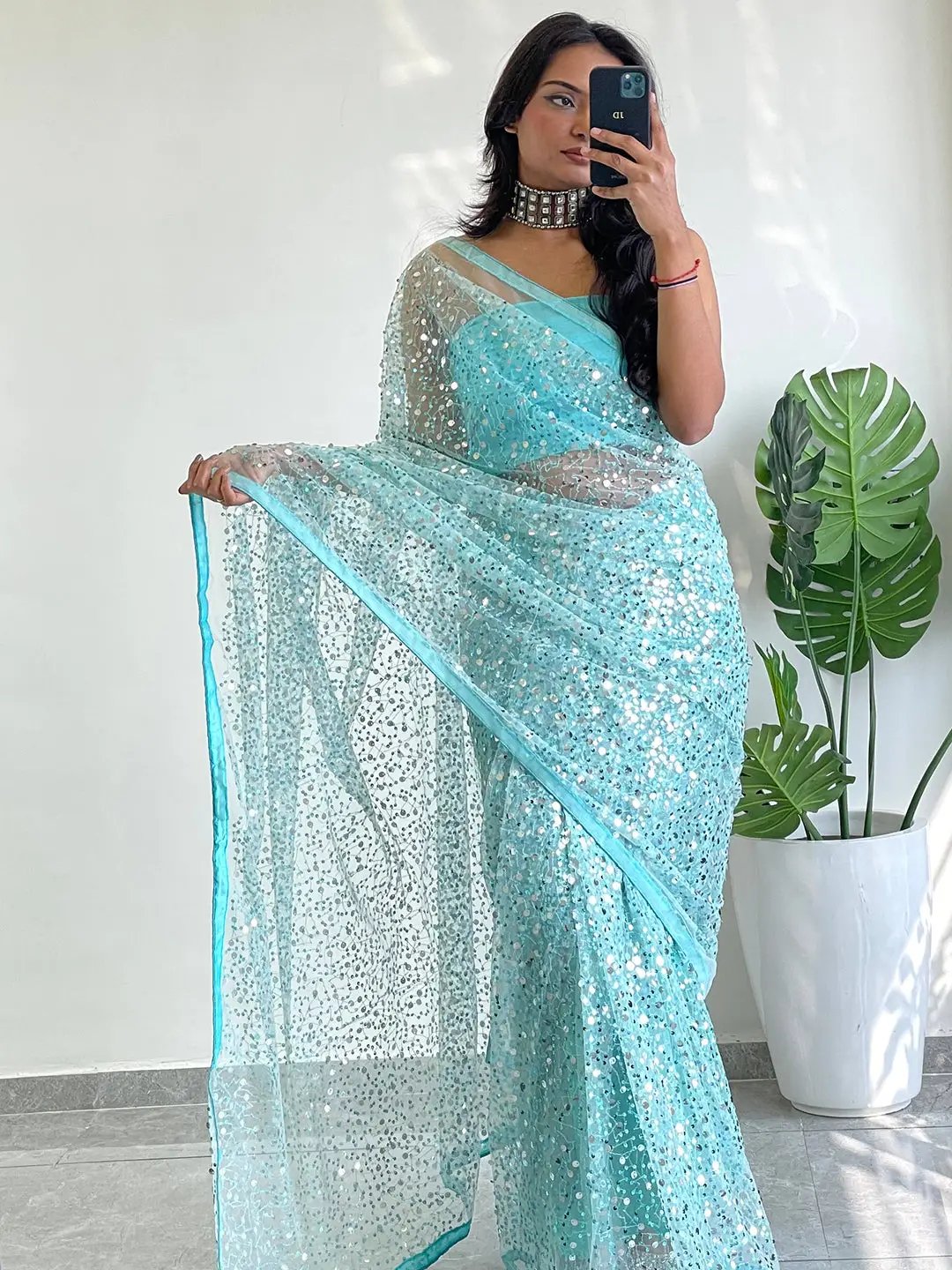 Stylish net saree with intricate sequins embroidery design