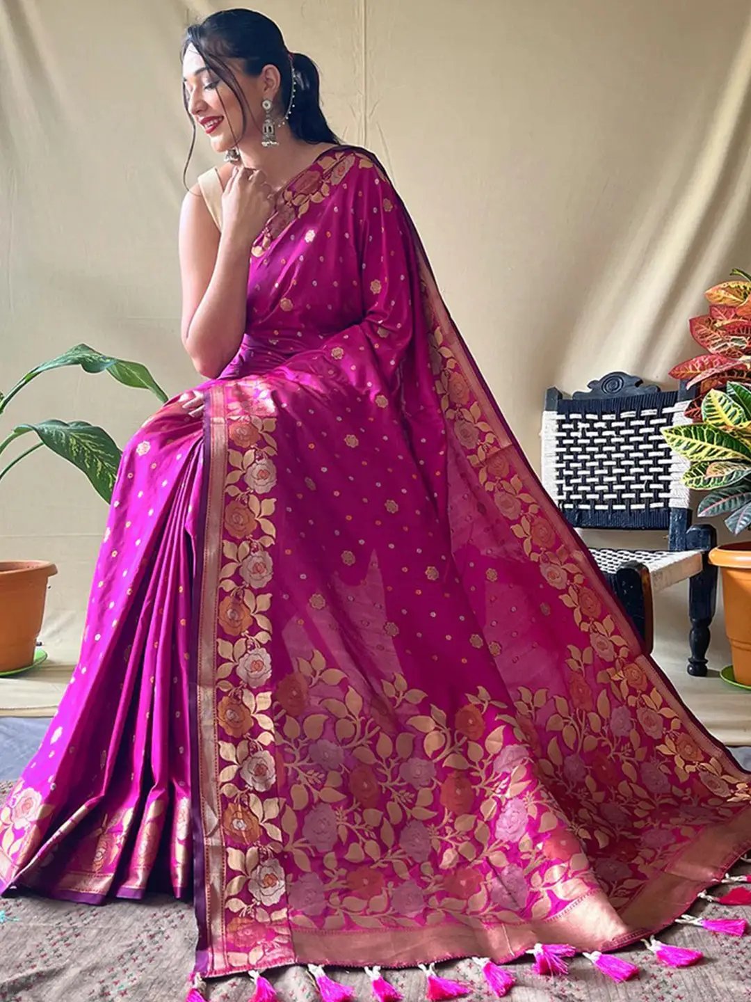 Traditional pink Banarasi saree featuring gold zari work