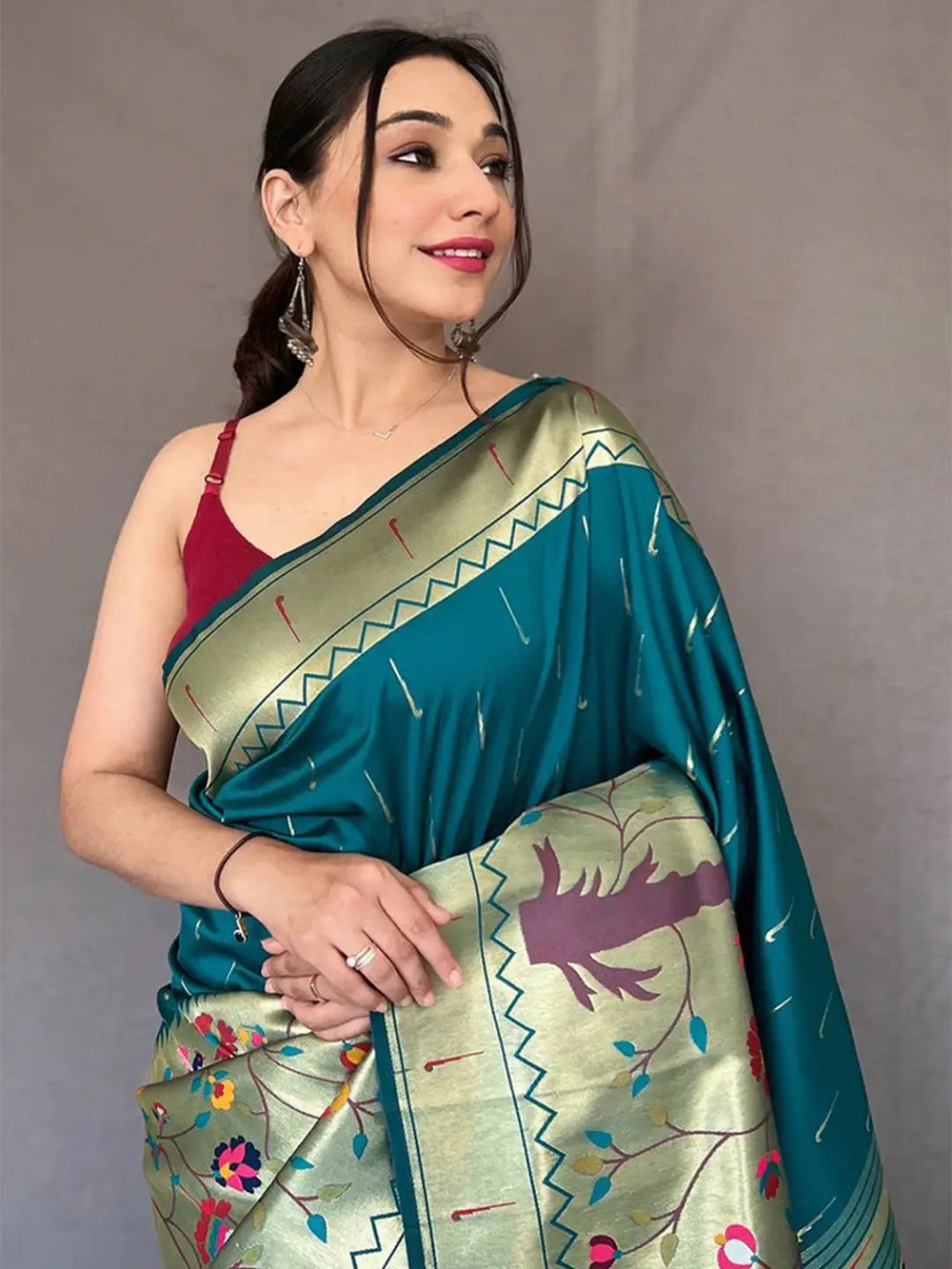 Close-up of teal Paithani saree with detailed zari work.