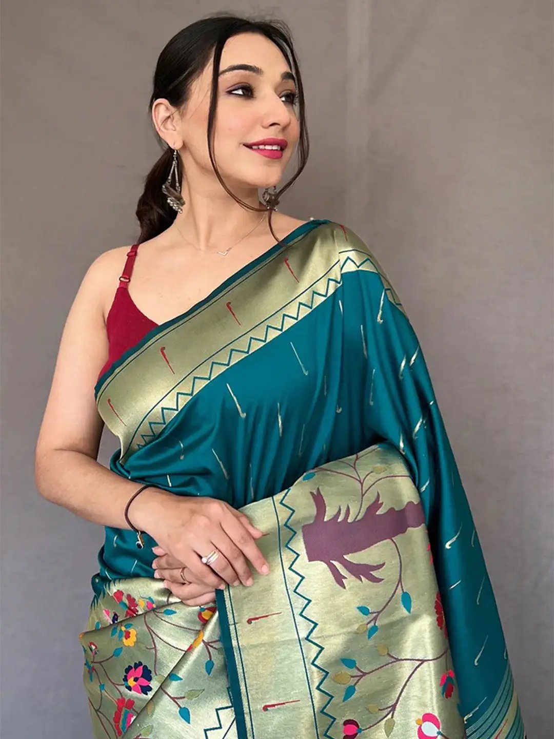 Close-up of teal Paithani saree with detailed zari work.