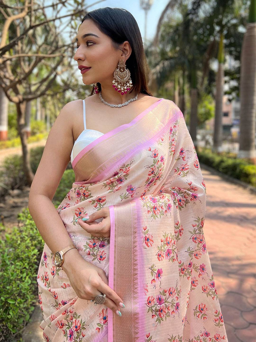 Close-up of peach Kota saree with intricate floral patterns