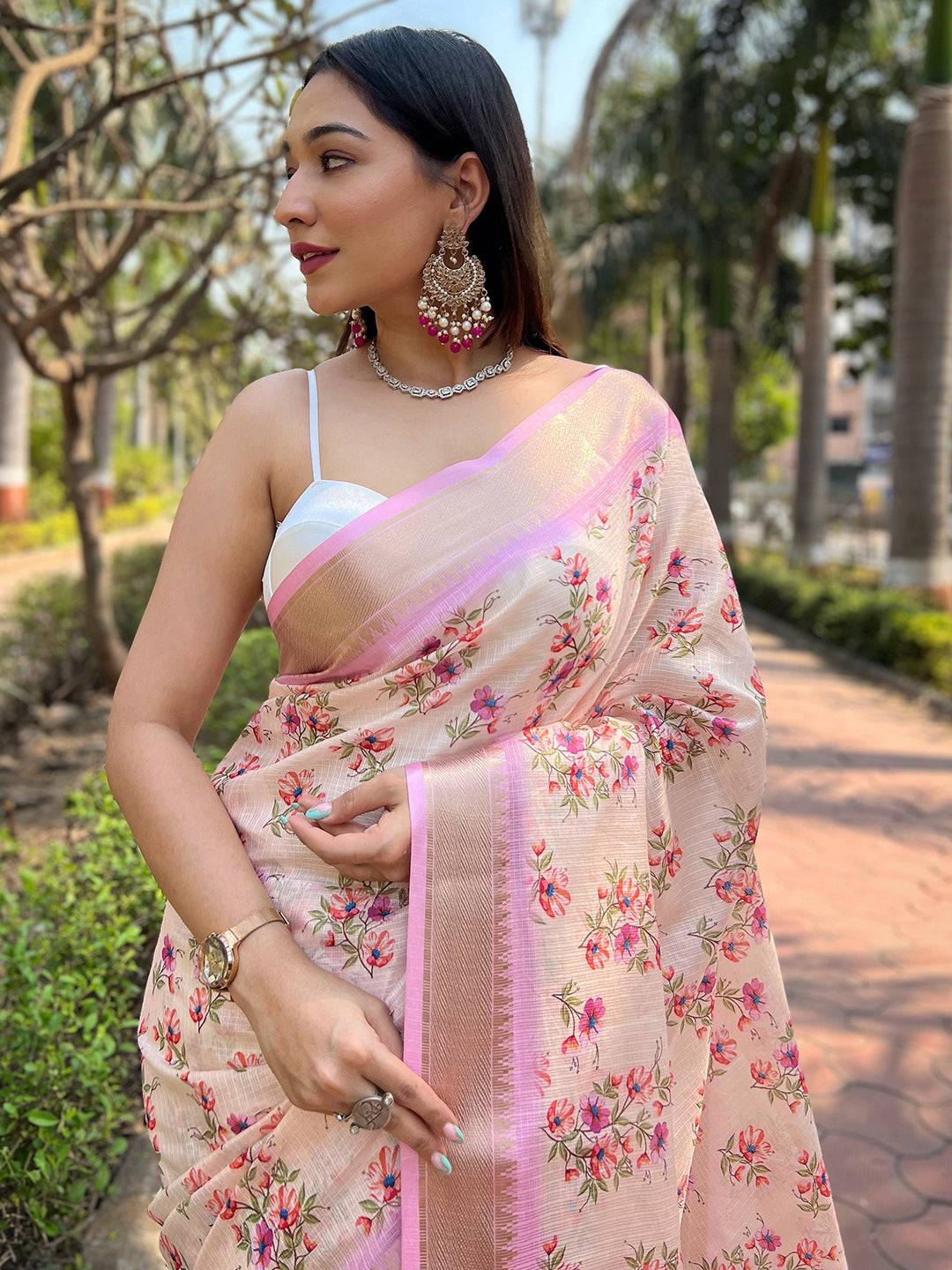 Close-up of peach Kota saree with intricate floral patterns