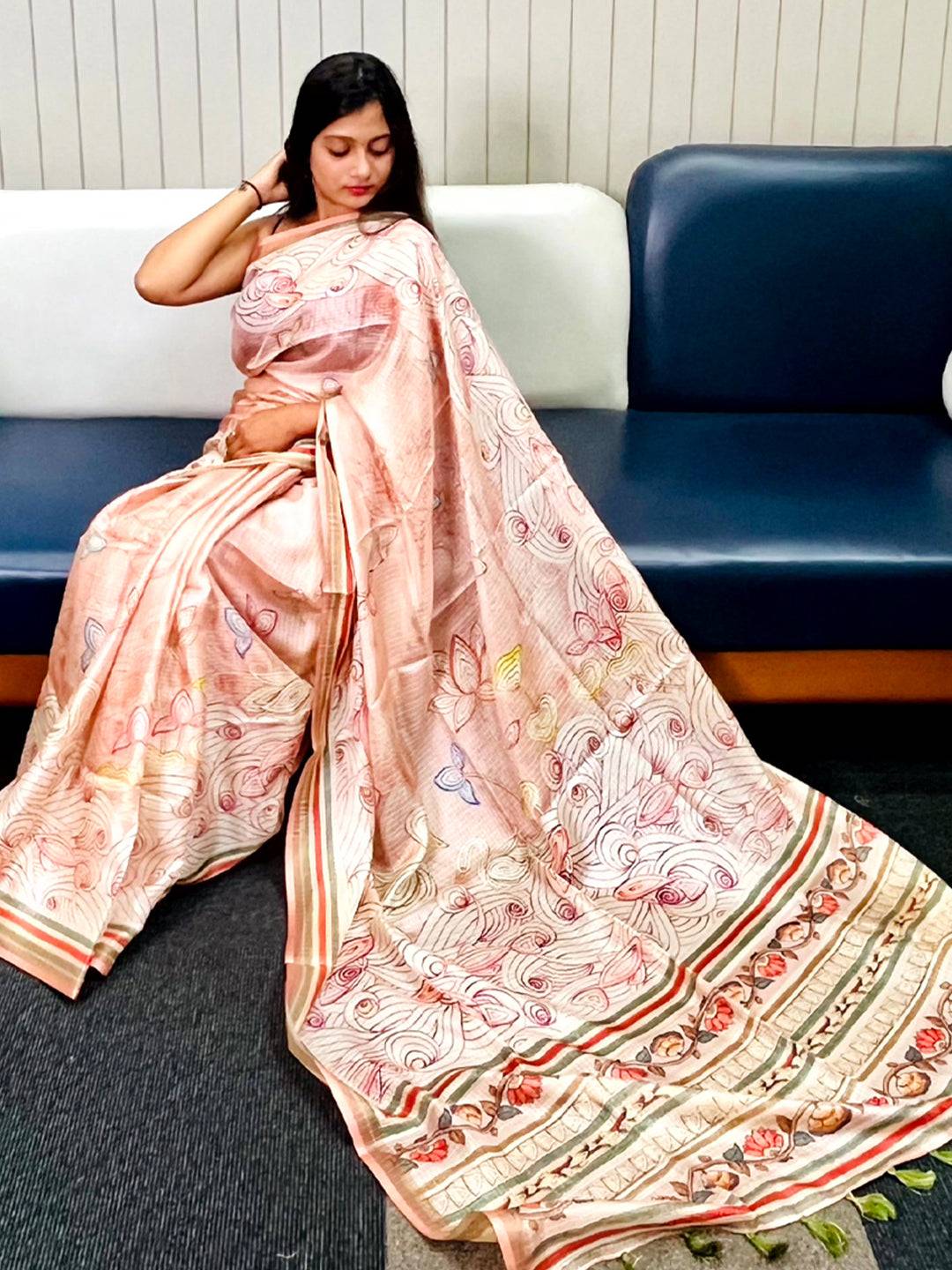 Peach Kota Doriya silk saree with floral Kalamkari print draped elegantly.