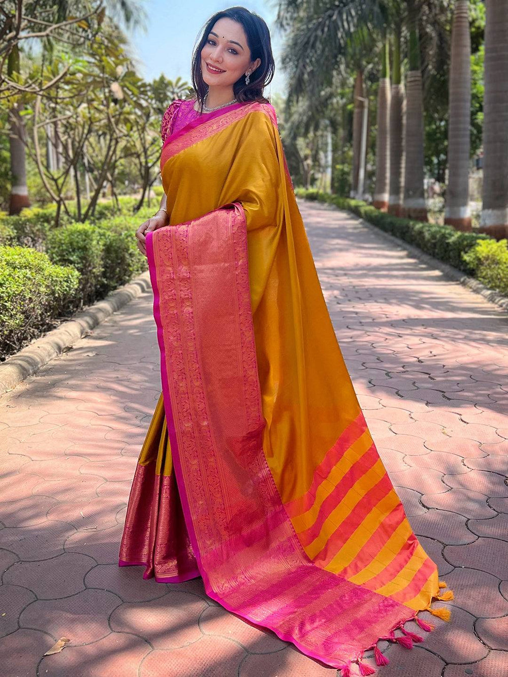 Elegant mustard Kanjivaram saree with pink border and pallu