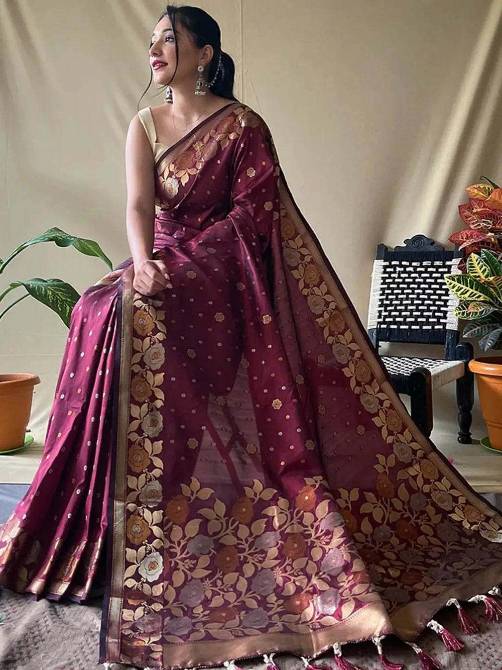 Model in wine Banarasi silk saree with gold zari motifs