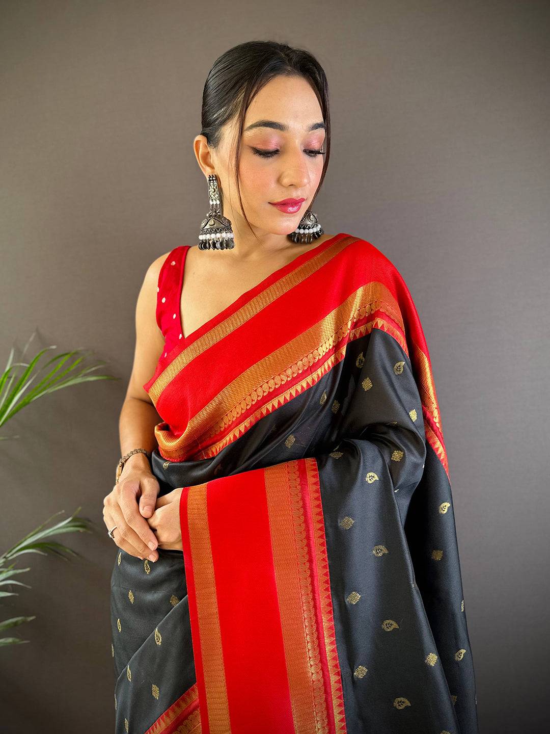 Elegant black Kanchi Rettepetta saree with red and gold accents