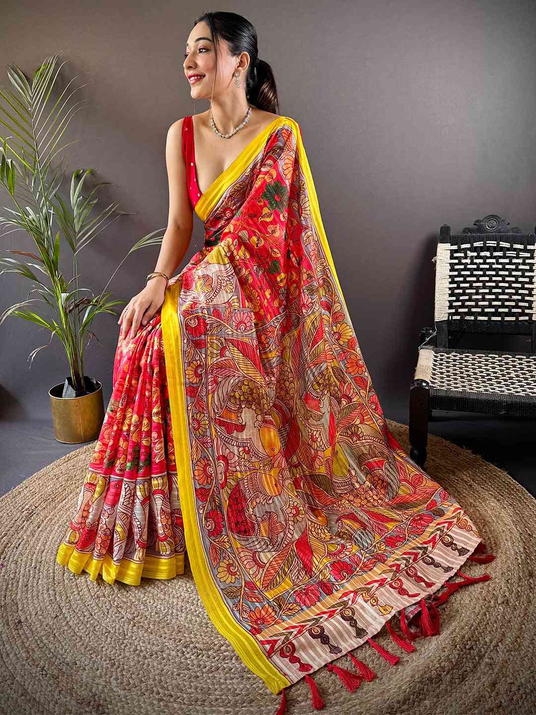 Seated model in Rose Red Pen Kalamkari Linen Saree