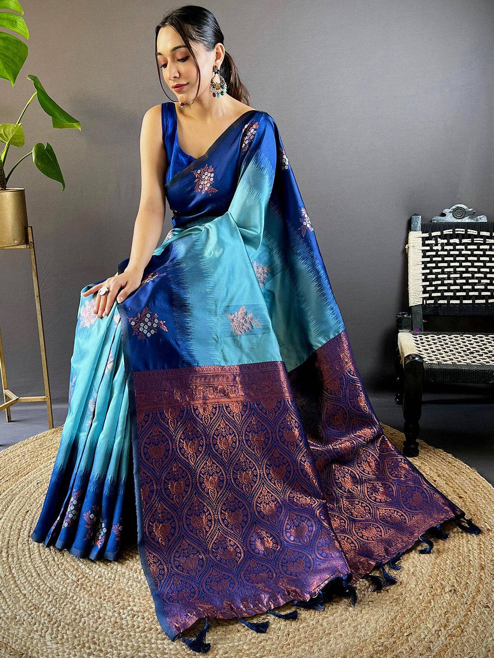 Seated model wearing sky blue Sami Banarasi Tussar silk saree