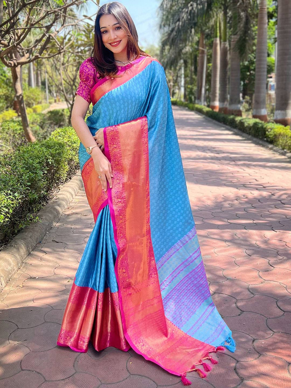 Model showcasing royal blue Kanjivaram silk saree outdoors