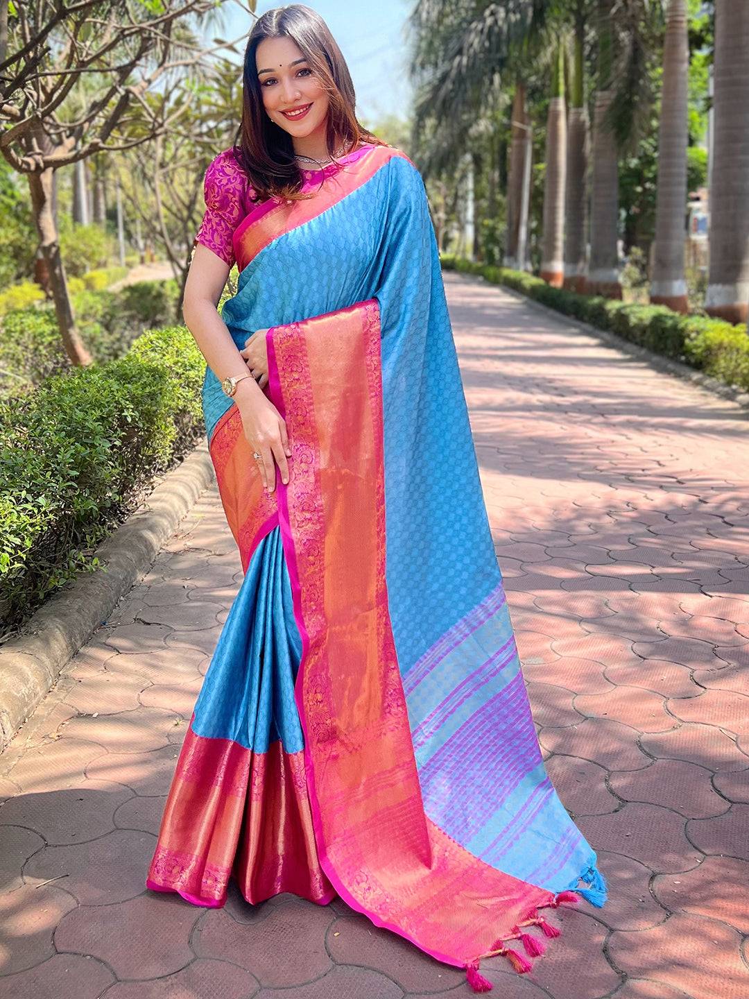 Model showcasing royal blue Kanjivaram silk saree outdoors