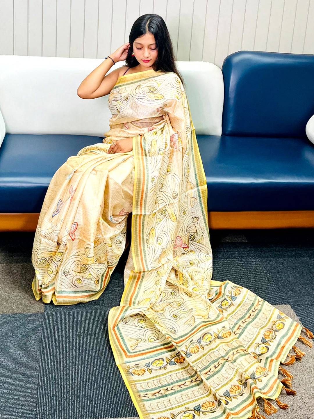 Yellow Kota Doriya silk saree with floral Kalamkari print draped elegantly.