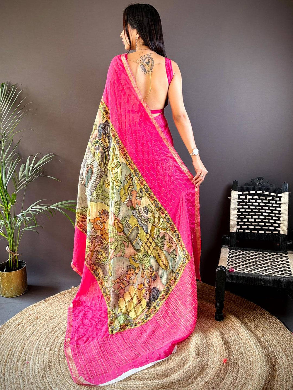 Back view of pink Kalamkari saree showcasing detailed artwork