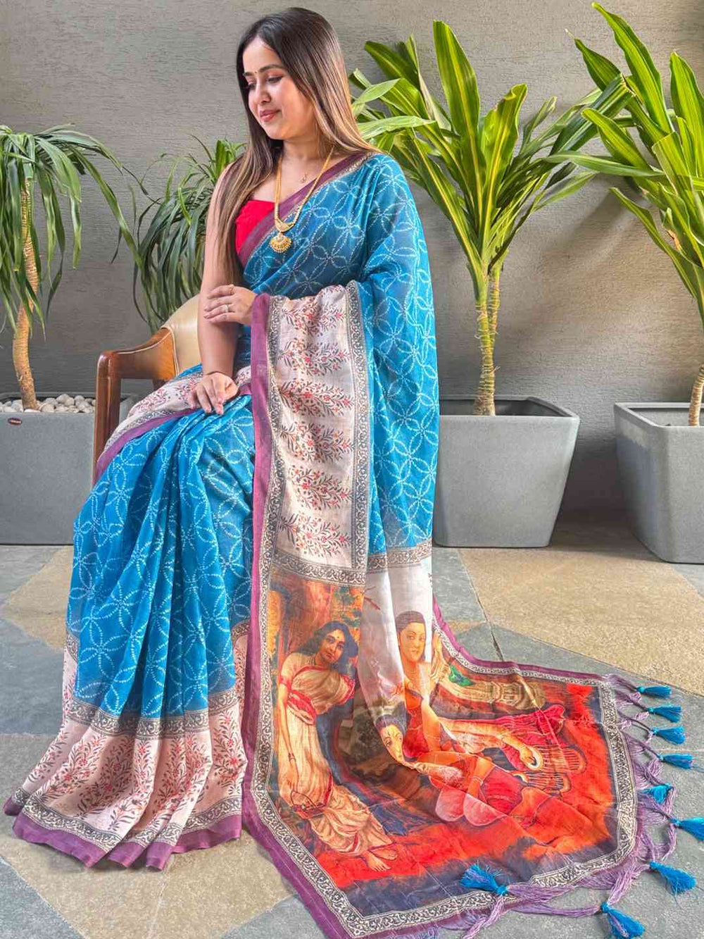 Blue geometric print saree with kalamkari design, seated model