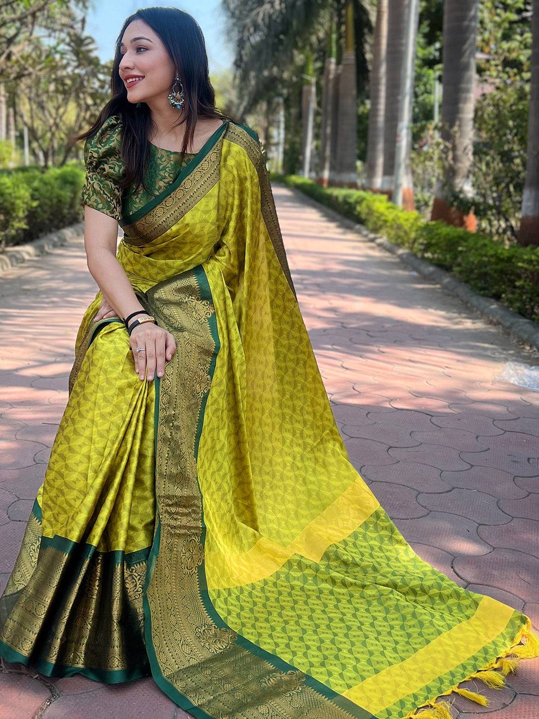 Stylish woman wearing green Kanjivaram silk saree in garden