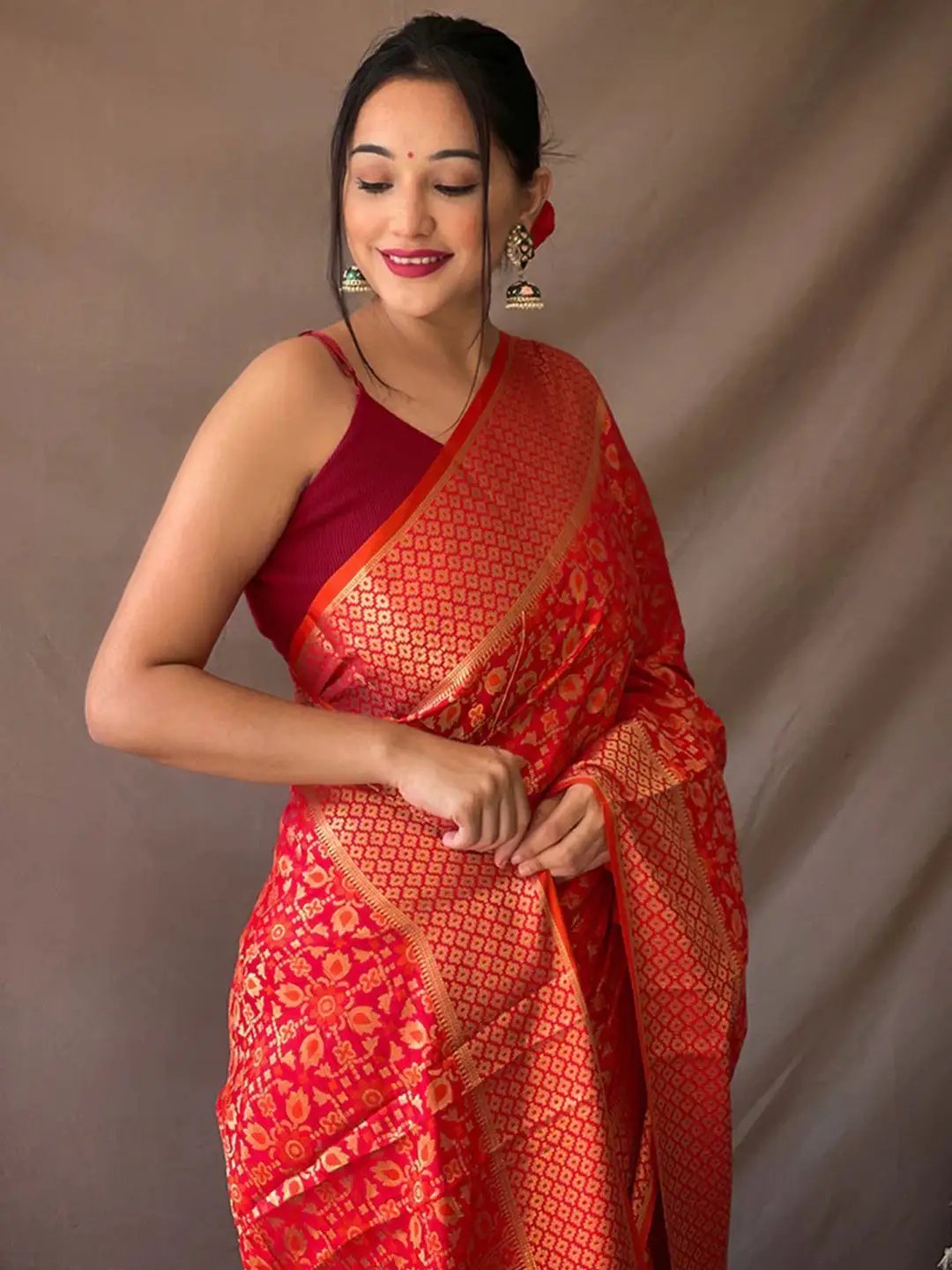 Close-up of red Rajkoti Patola silk saree with zari details