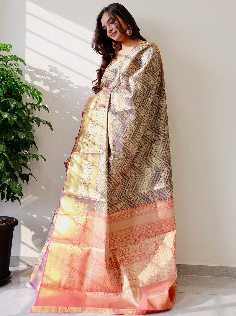Elegant gold zari Kanjivaaram silk saree draped on model.
