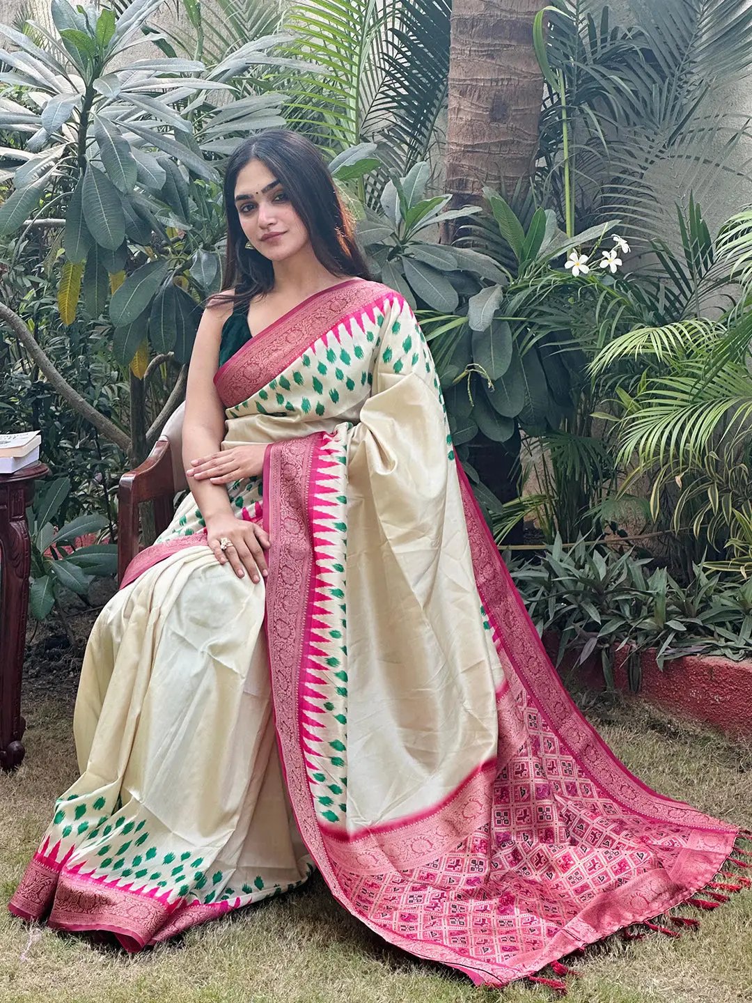 Cream Banarasi silk saree with pink Patola pallu, garden setting
