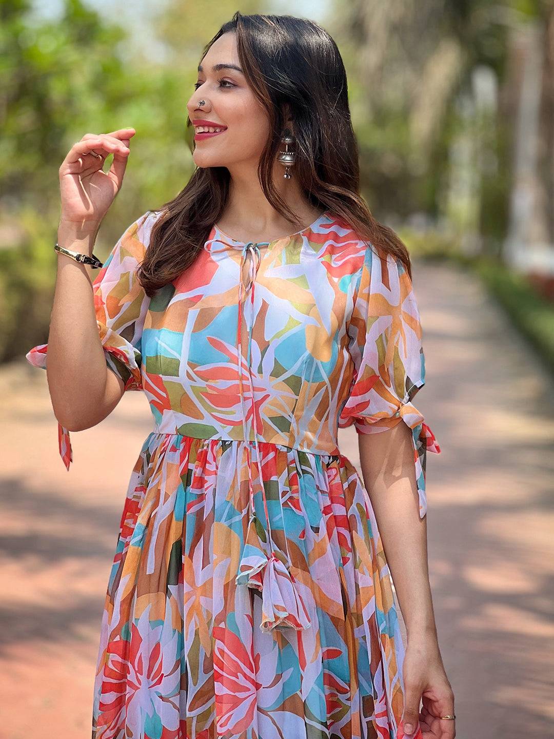 Close-up of woman in floral abstract dress smiling
