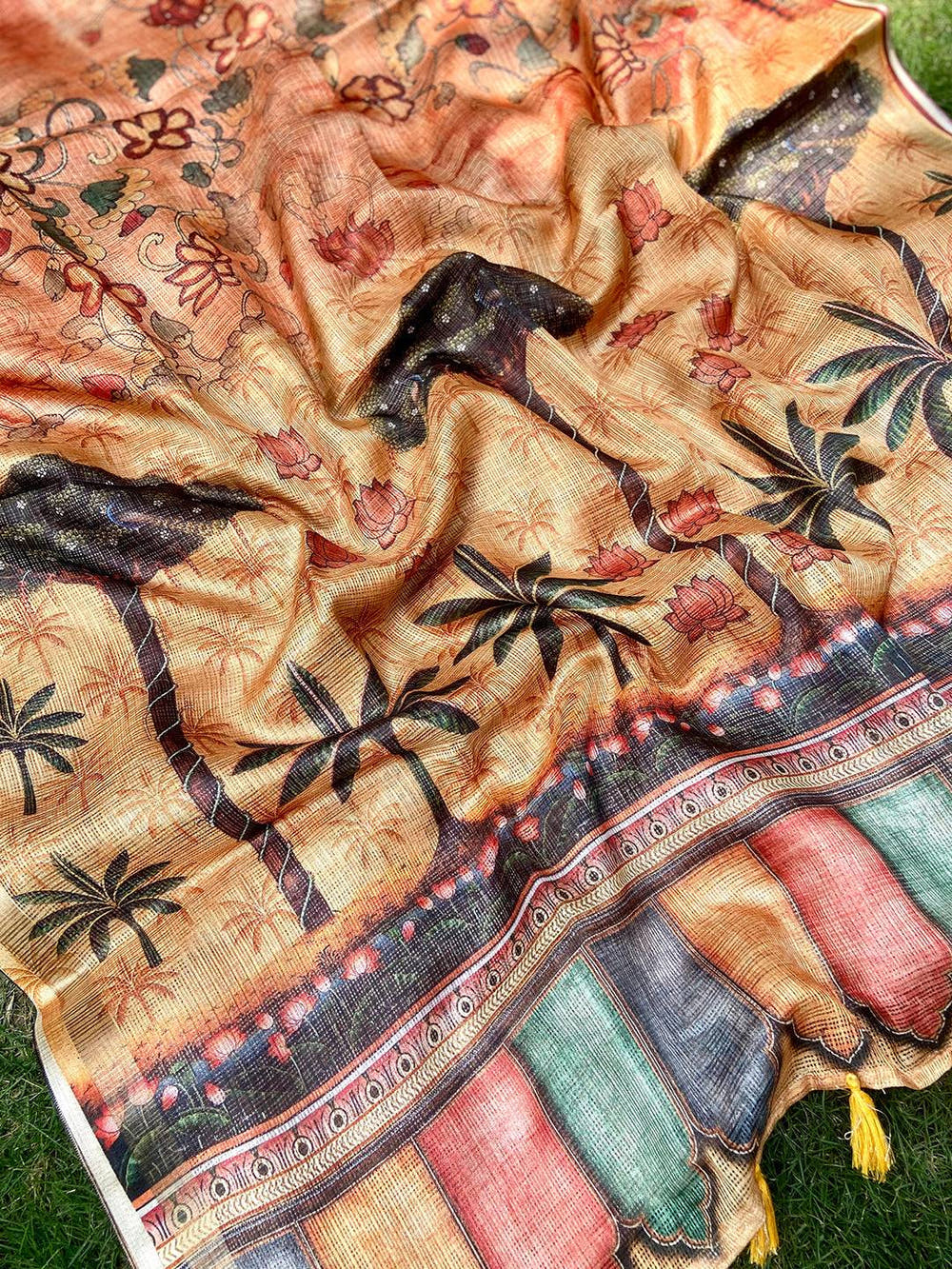 Detailed view of orange Kota Doriya silk saree with floral design.